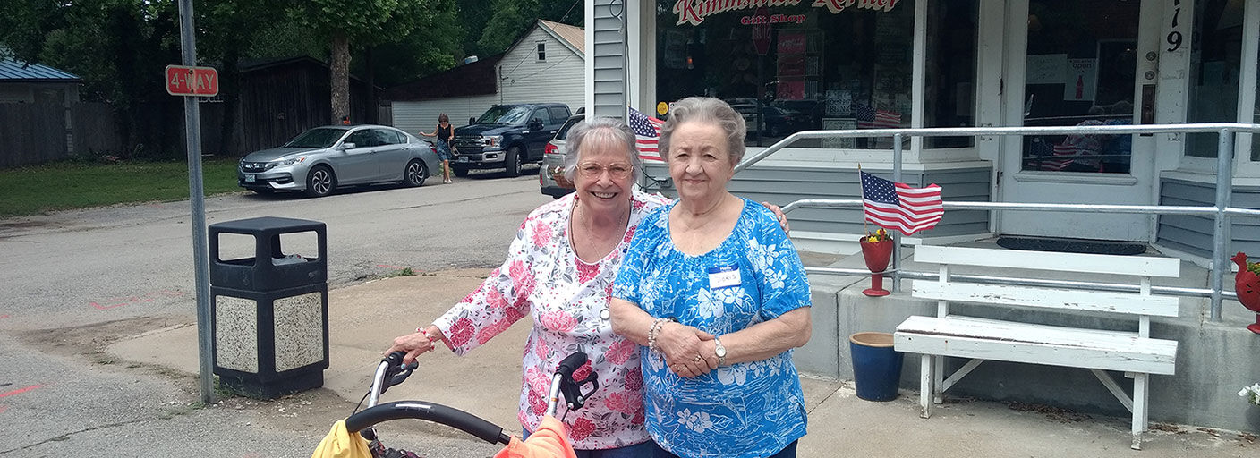 Lois and Diane, Wyndham Park residents, pose in front of Kimmswick Korner.