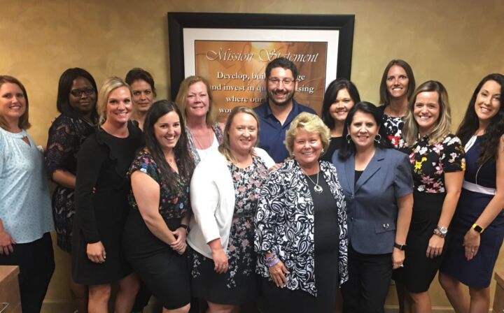 Employees standing together during training