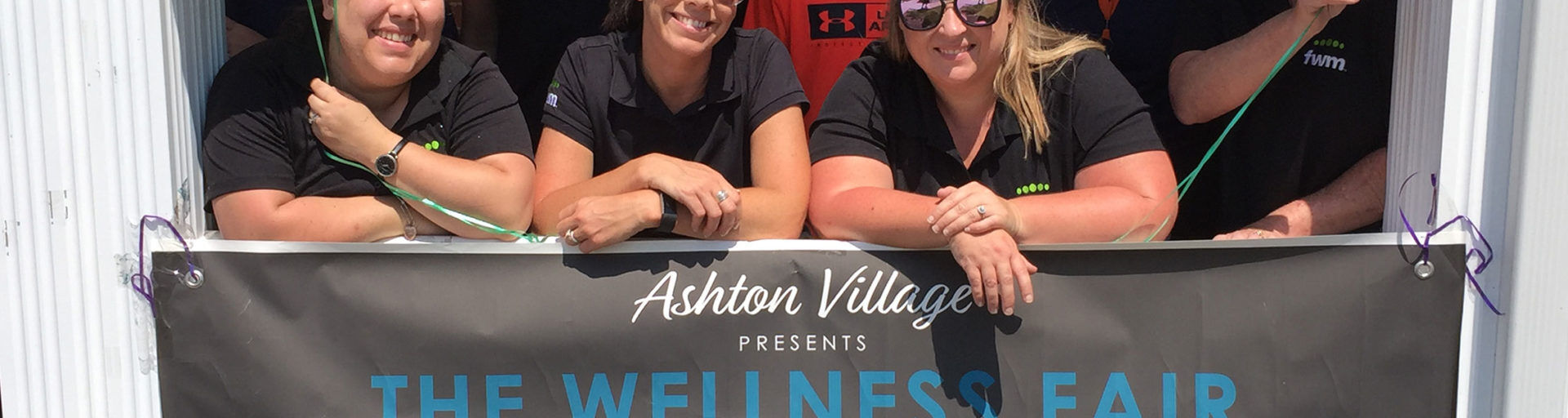 People standing behind a banner