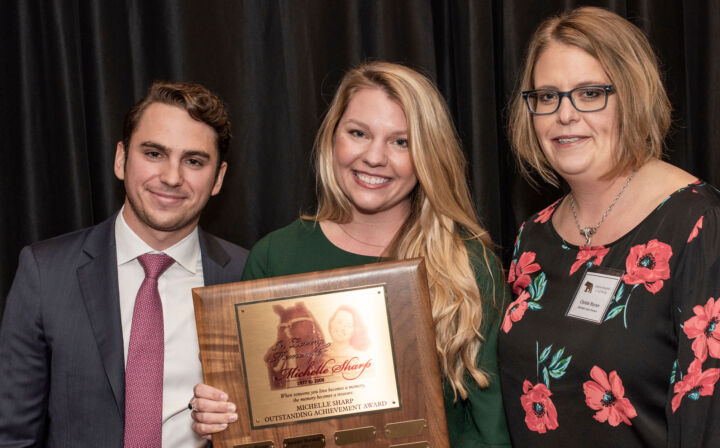 Walker Smith, President of JES Holdings, Blair Jones, the Michelle Sharp Outstanding Achievement Award 2018 recipient, and Christie Haynes, AEP Vice President of Transactions & Asset Management, celebrate at JES Holdings’ employee recognition.