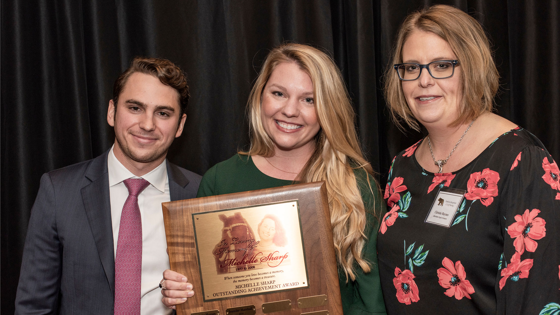 Walker Smith, President of JES Holdings, Blair Jones, the Michelle Sharp Outstanding Achievement Award 2018 recipient, and Christie Haynes, AEP Vice President of Transactions & Asset Management, celebrate at JES Holdings’ employee recognition.